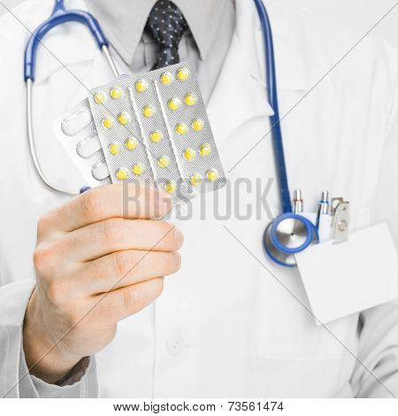 Doctor Holdling Pills In His Hand