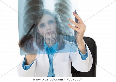 Young female doctor examining an x-ray image