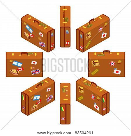 Set of standing brown traveler`s suitcases