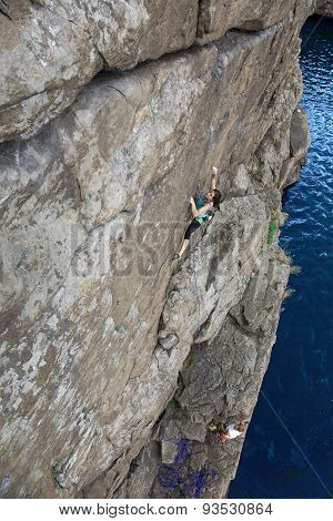 Climbing partners make ascent on to the rock wall