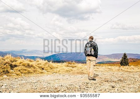 Man With Backpack Hiking In Spring