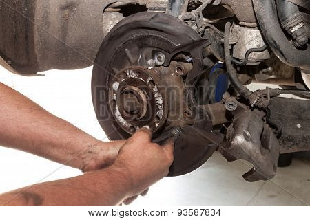 mechanic fixes brakes