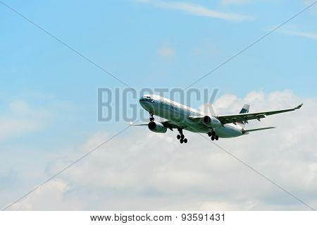 HONG KONG - JUNE 04, 2015: Cathay Pacific aircraft landing. Cathay Pacific is the flag carrier airline of Hong Kong, with its head office and main hub located at Hong Kong International Airport