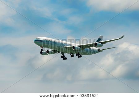 HONG KONG - JUNE 04, 2015: Cathay Pacific aircraft landing. Cathay Pacific is the flag carrier airline of Hong Kong, with its head office and main hub located at Hong Kong International Airport