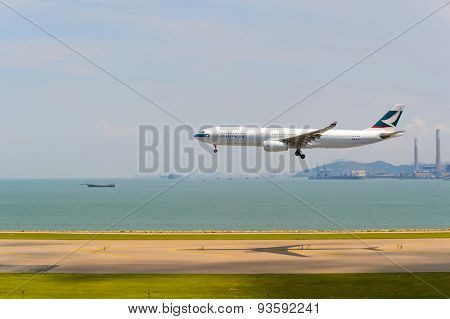HONG KONG - JUNE 04, 2015: Cathay Pacific aircraft landing. Cathay Pacific is the flag carrier airline of Hong Kong, with its head office and main hub located at Hong Kong International Airport