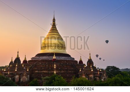 Dhammayazika pagoda in misty morning light in Bagan. This Dhammayazika  pagoda gilded with Bagan gold leaves is ancient and most visited in Bagan. It is located east of Bagan, Myanmar.