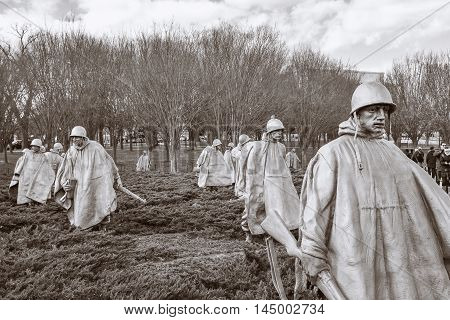WASHINGTON, DC - DEC 19: Korean War Veterans Memorial in Washington, DC, as seen on December 19, 2015. The memorial consists of 19 stainless steel statues. This is a sepia version of the shot.