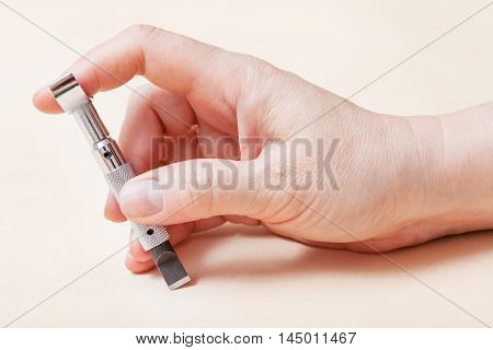 Hand With Swivel Knife On Leather Surface