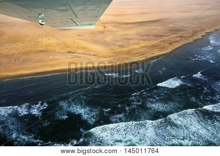 Flight over the Sceleton coast in Namibia where dunes of the Namib desert meet with Atlantic ocean Africa