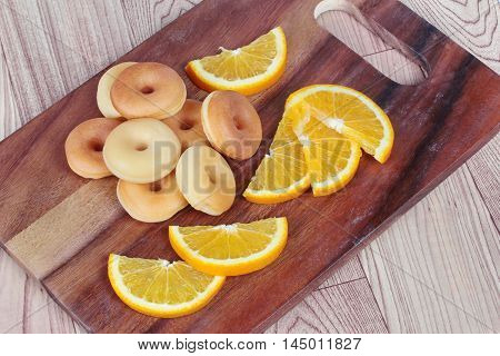 donuts with sliced orange home made on wood.