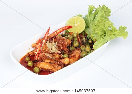 Spicy fried chicken in roasted chili sauce on white background.
