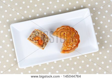 A dish of Mooncake filling five seed and salt eggs on brown.