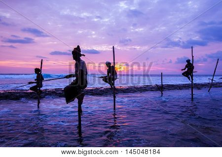 AHANGAMA - NOVEMBER 27 : Still fisherman's fishing fish at sunset on November 27 2015 in Ahangama Sri Lanka