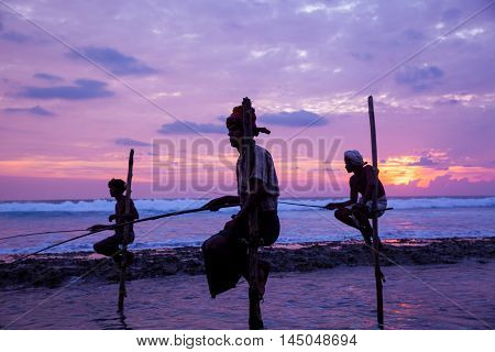 AHANGAMA - NOVEMBER 27 : Still fisherman's fishing fish at sunset on November 27 2015 in Ahangama Sri Lanka