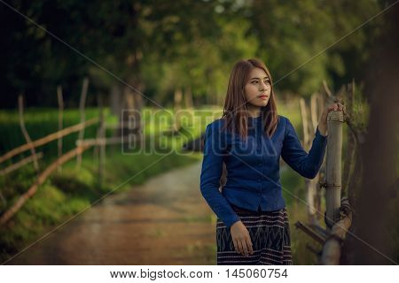 Thai woman wearing typical Thai dress on Rice fields Buffalo River background identity culture of Thailand