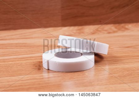 Pair roll's of double sided tape on wooden background