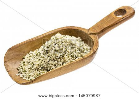 hemp seed hearts on a rustic wooden scoop, isolated on white
