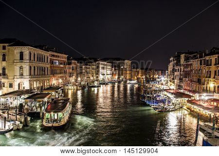 Canal with boats and gondola in romantic Venice