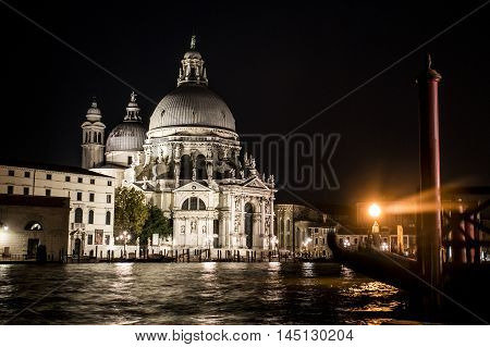 Cathedral at the big Canal with boats and gondola in romantic Venice