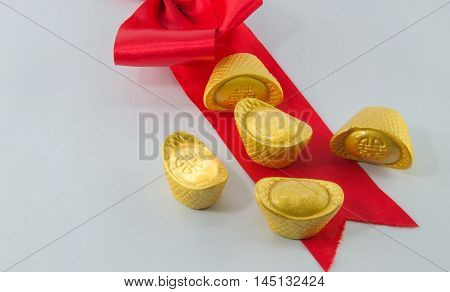 Gold ingot Red ribbon bow on white background.