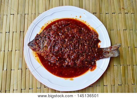 deep fried mango fish dressing chili sauce on plate