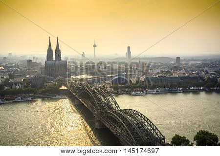 Koln Cityscape With Cathedral And Steel Bridge, Germany