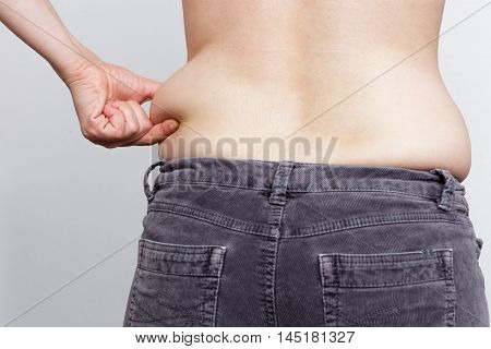 Girl Is Holding Her Fat Side. Result Of Improper Diet