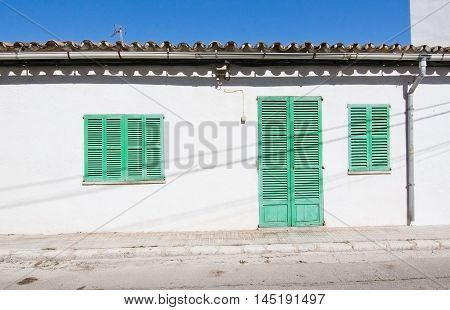 White Building With Green Shutters In El Terreno