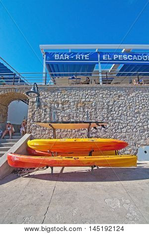 Stacked Plastic Canoes And El Pescador Restaurant