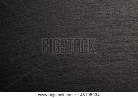Black slate background. Deep black stone texture.