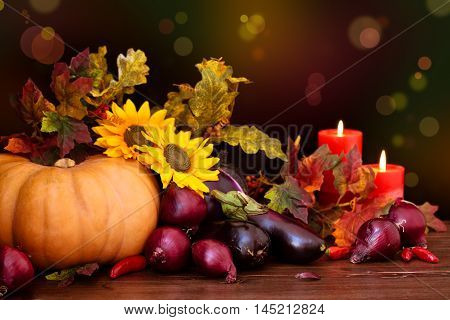 Arrangement of utumnal vegetables against defocused holiday lights.