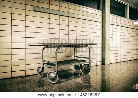 Old vintage metal stretcher in horror hospital