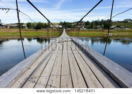 Rural Landscape At Summer With Wooden Suspension Bridge