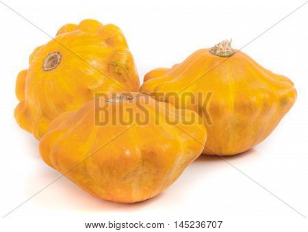 three yellow pattypan squash isolated on white background.