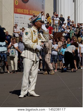 MOSCOW, RUSSIA - August 27, 2016: Bandmaster of brass band from Kazakhstan asks the audience what musical composition to perform. Festival of military orchestras 