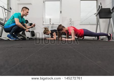 Group Of Sportive People In A Gym Training