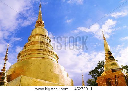 Uprisen angle of Thai golden buddism pagoda under deep blue sky