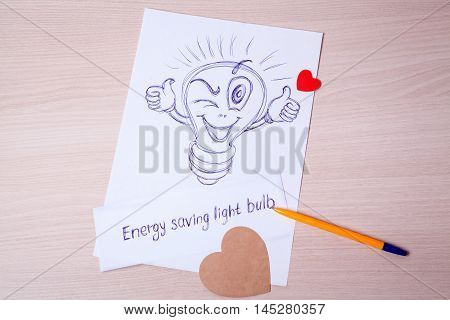 Decorative pattern of energy-saving light bulbs. Joyful happy smiley painted pen on a sheet of paper