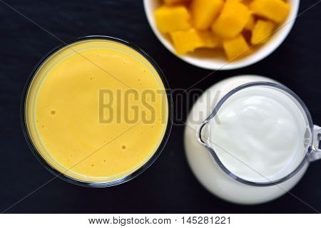 Mango lassi. Mango smoothie made with mango and yogurt yoghurt. Selective focus. Top view.