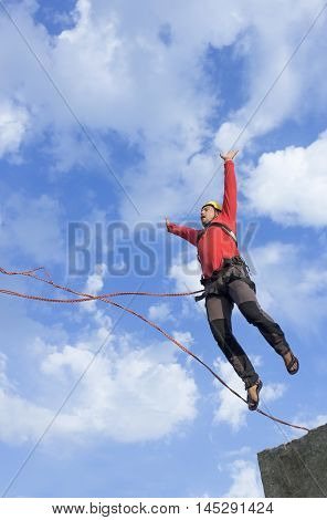 The first jump off the cliff with a safety rope.
