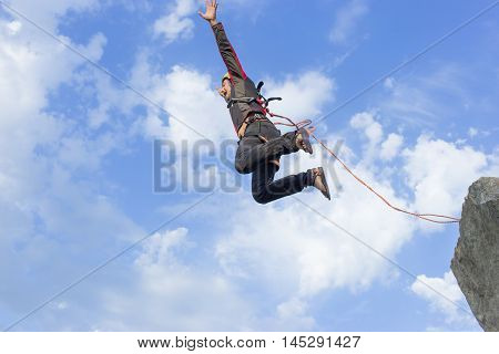 The first jump off the cliff with a safety rope.