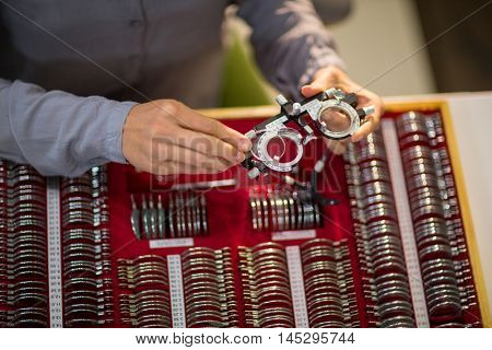 Mid section of woman preparing messbrille in optical store