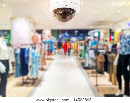 CCTV Security camera shopping department store on background.
