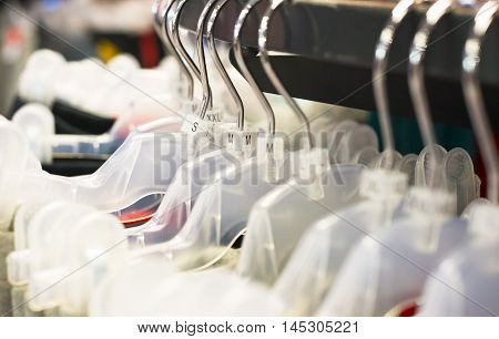 close up of plastic clothes hanger with sizing labels.