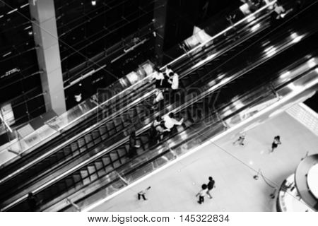 People on escalator Intentionally blurred editing post production. black and white picture style