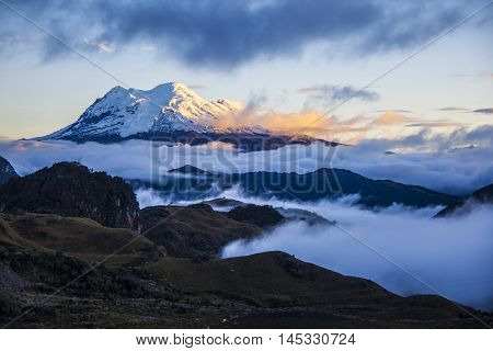 Antisana volcano with glaciers in golden tones it dusk