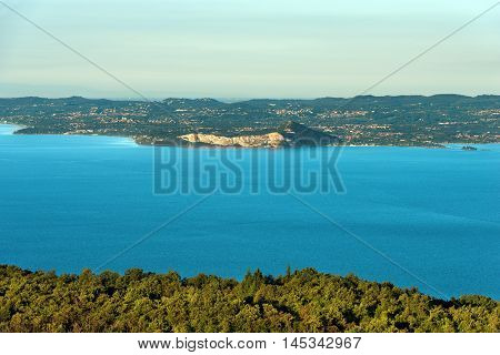 Lago di Garda (Garda Lake) the largest Italian lake of glacial origin. The Veneto coastline in the foreground in the background the coast of Lombardy