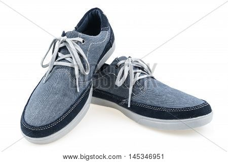 Picture of a pair of blue trainers over a white background. Selective focus.
