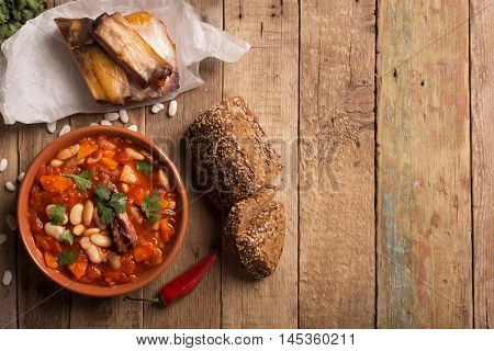 Rustic Kidney Bean Soup with beans and carrot. On the wooden table