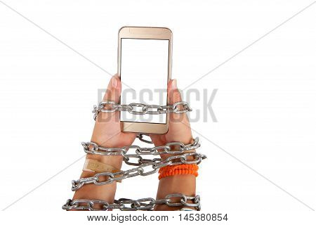 Chained hands of a child holding a smartphone with white screen. Smartphone Internet addiction concept. Studio isolated on white background.